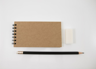 Brown cover notebook with pencil and eraser.