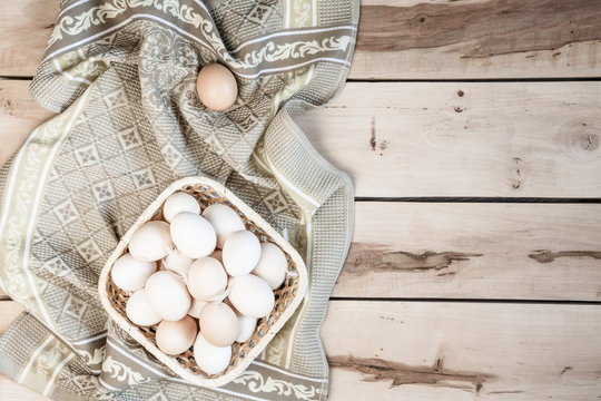 Raw eggs on the wooden background
