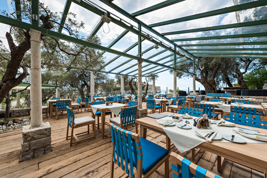 Interior of a summer terrace of restaurant. Sea view on islet Saint Stephen in Montenegro