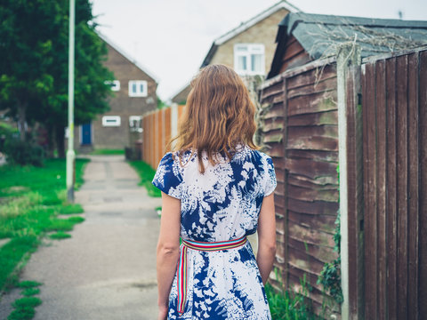 Young woman walking residential neighbourhood