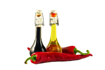 Two bottles of wine vinegar, olive oil and two red hot chilly pe