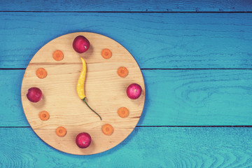 Obraz na płótnie Canvas Clock dial made from vegetables
