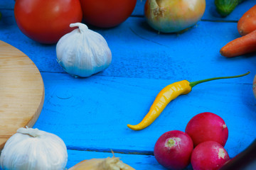 Healthy vegetables mix and cutting board on table