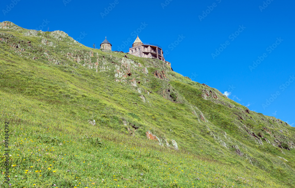 Wall mural 14th century Holy Trinity Church (Tsminda Sameba) near Mount Kazbek in Georgia