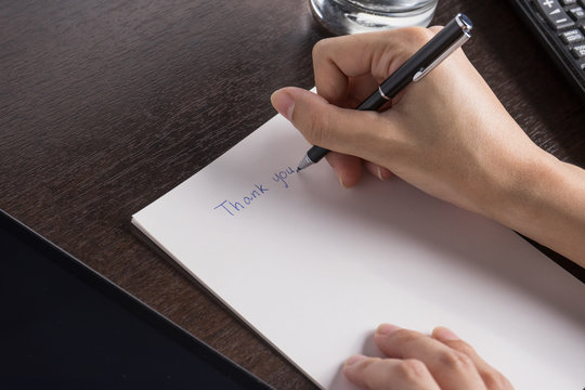 close up of woman with tablet and write a paper "Thank you" on w