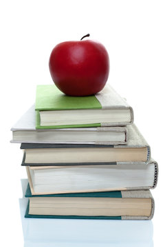 Stack of books with a red apple on top