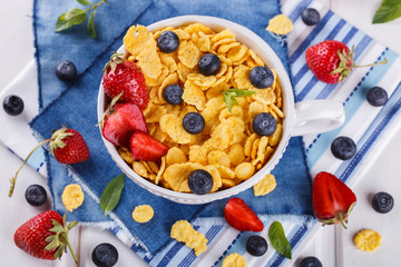 Corn flakes and fresh berries, for Breakfast. selective focus