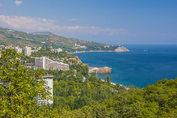 Fototapeta na wymiar Small town on the Black Sea coast against blue sky with clouds.