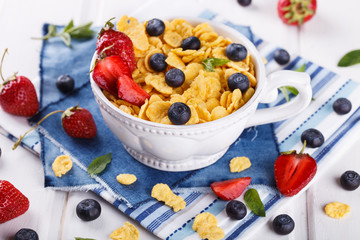 Corn flakes and fresh berries, for Breakfast. selective focus