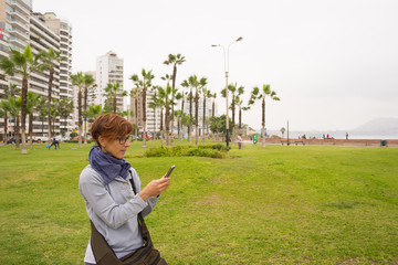Fototapeta premium Checking smart phone in Lima Miraflores