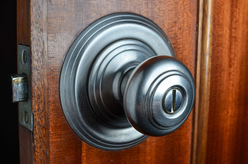 Fototapeta premium metal door knob on open wooden door with latch
