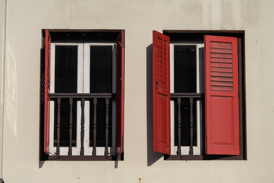 Red shutter on a white house