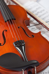 Fototapeta premium Old violin lying on the sheet of music, music concept