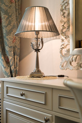 interior luxury apartment, detail room, dresser and table lamp