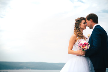 beautiful young couple posing in the park on a background of nature