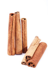 group of dried cinnamon stics isolated on white background