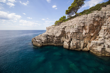 Fototapeta premium Steep and rugged cliff and shallow water at the Lokrum Island in Croatia.