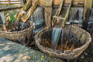 Traditional natural wash machine under a stream of water in Maramures