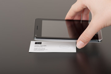Business card with embedded NFC tag and phone