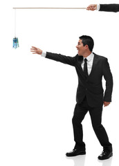 Excited businessman reaching for euor bills on a stick