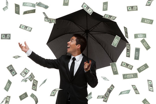Business Man With Umbrella Raining Money