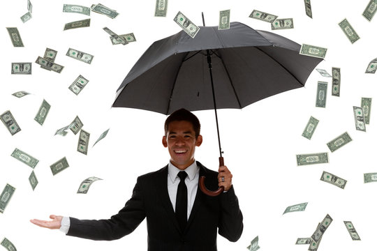 Half-body of a business man holding an umbrella in raining money