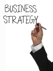 Hand writing the words business strategy