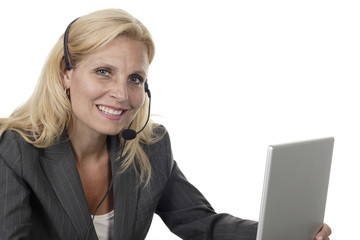 Woman with Headset and Laptop Smiles at Camera