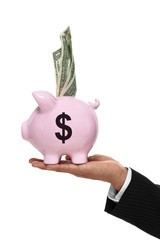 Businessman hand holding a piggy bank with a money sign and mone