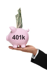 Businessman hand holding a piggy bank for 401k savings and money