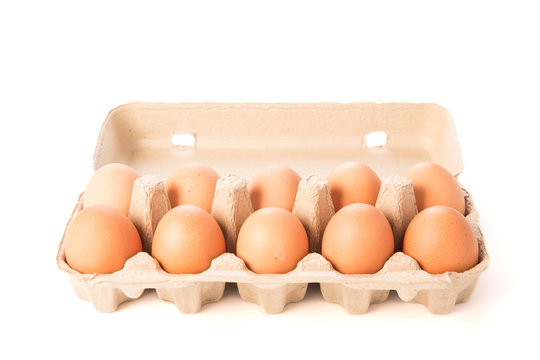 Cardboard egg box with ten brown eggs isolated