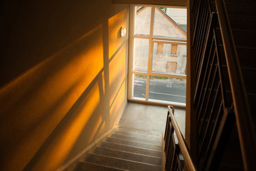 Staircase of apartment building with sunset light playing on the
