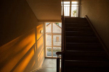 Staircase of apartment building with sunset light playing on the