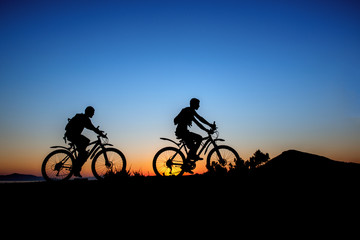 Silhouette of a men on mountain bike at sunset
