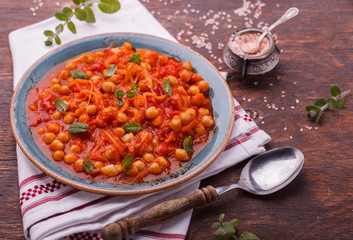  Chickpeas with tomatoes, decorated with mint.selective focus