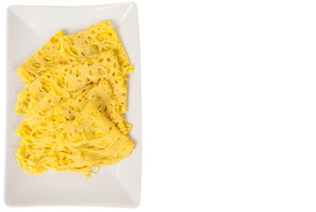 Malaysian dish Net Pancake or locally known as Roti Jala on white plate over white background. Usually served with beef curry.