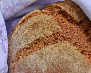 Close-up of healthy fresh homebaked traditional bread made using Natural Starter and organic wholegrain wheat flour. Healthy food concept.