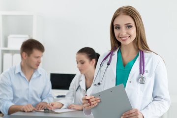 Fototapeta premium Portrait of smiling female medicine doctor with her colleague co