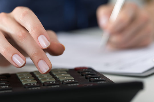 Close up of female accountant or banker making calculations