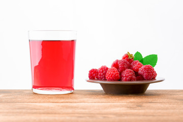 raspberry and juice on wood  table