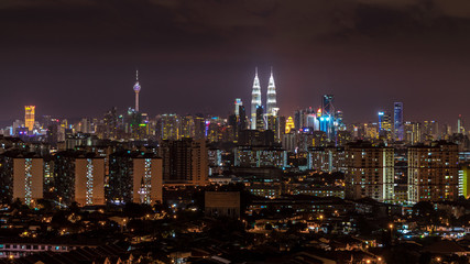 Fototapeta na wymiar KUALA LUMPUR, MALAYSIA - 30TH AUGUST 2014; Kuala Lumpur, the capital of Malaysia, or KL by locals. Its modern skyline is dominated by the 451m-tall KLCC, a pair of glass-and-steel-clad skyscrapers.