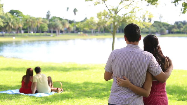 Young couple in park in love - exchanging words possible proposal