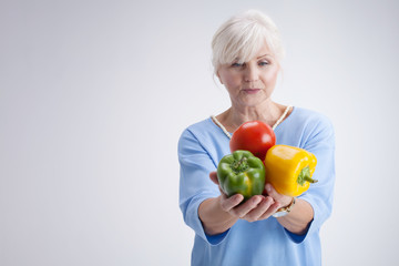 Senior woman with vegetables.