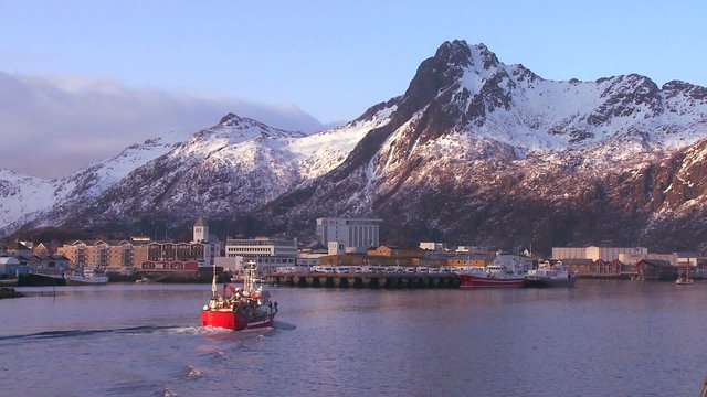A fishing boat arrives at Svolvaer, the capital city of the Lofoten islands, Norway.