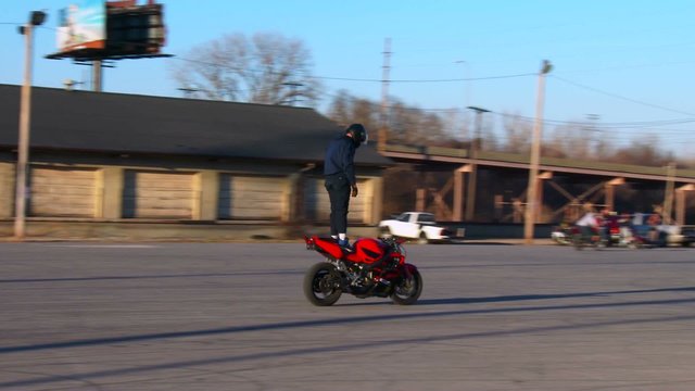 A rider performs amazing stunts on a motorcycle.