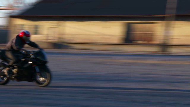 A rider performs amazing stunts on a motorcycle in slow motion.