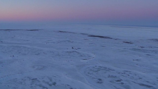An aerial over the frozen arctic region of Hudson bay, Canada at sunset or sunrise.