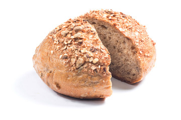 Fresh whole grain bread cut in half on white background
