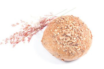 Fresh whole grain bread cut in half on white background
