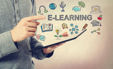 Young man pointing at E-Leaning concept over a tablet